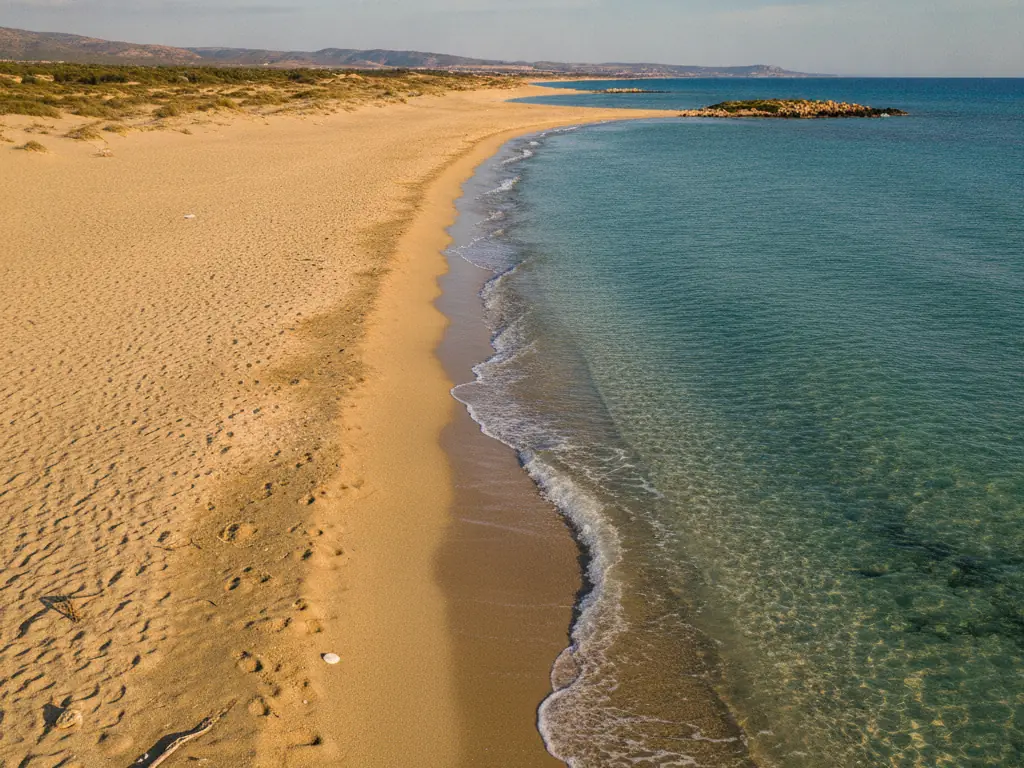Golden sands and turquoise shallows of Karpaz Peninsula's Golden Beach stretching endlessly.