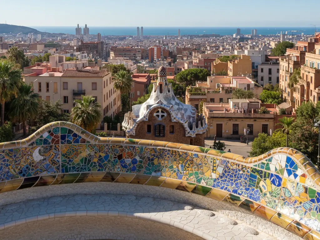 Park Güell's colorful mosaic serpent bench overlooking Barcelona's terracotta rooftops and Mediterranean coastline.