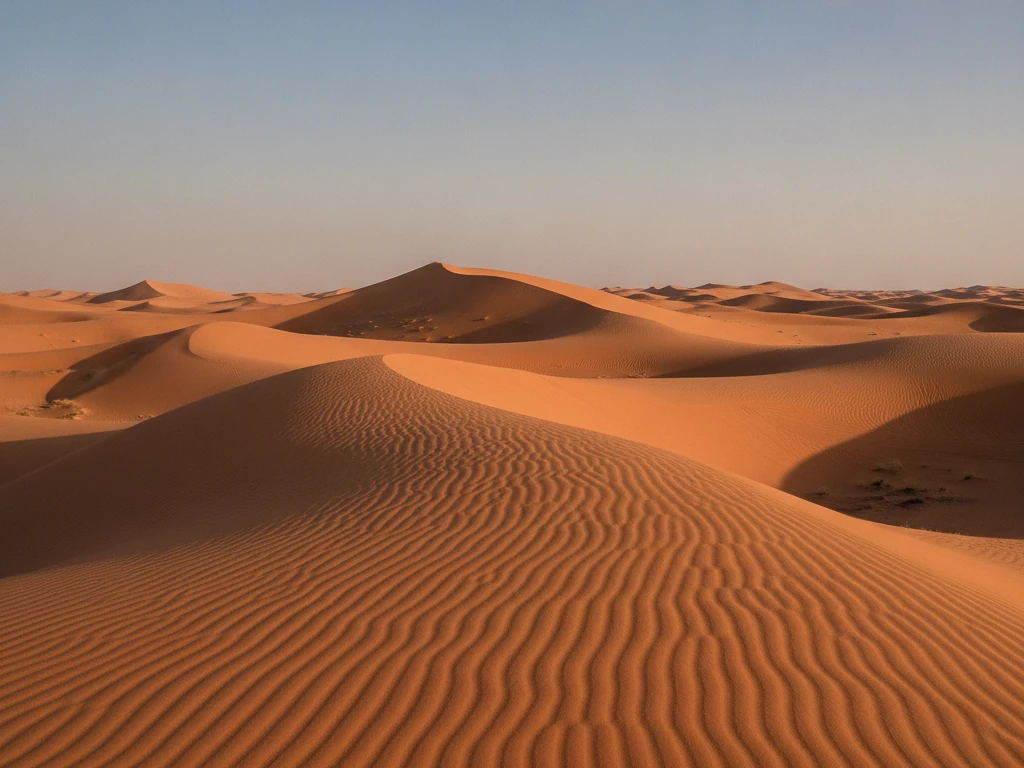 Liwa Desert's towering orange sand dunes stretching endlessly beneath blue skies.