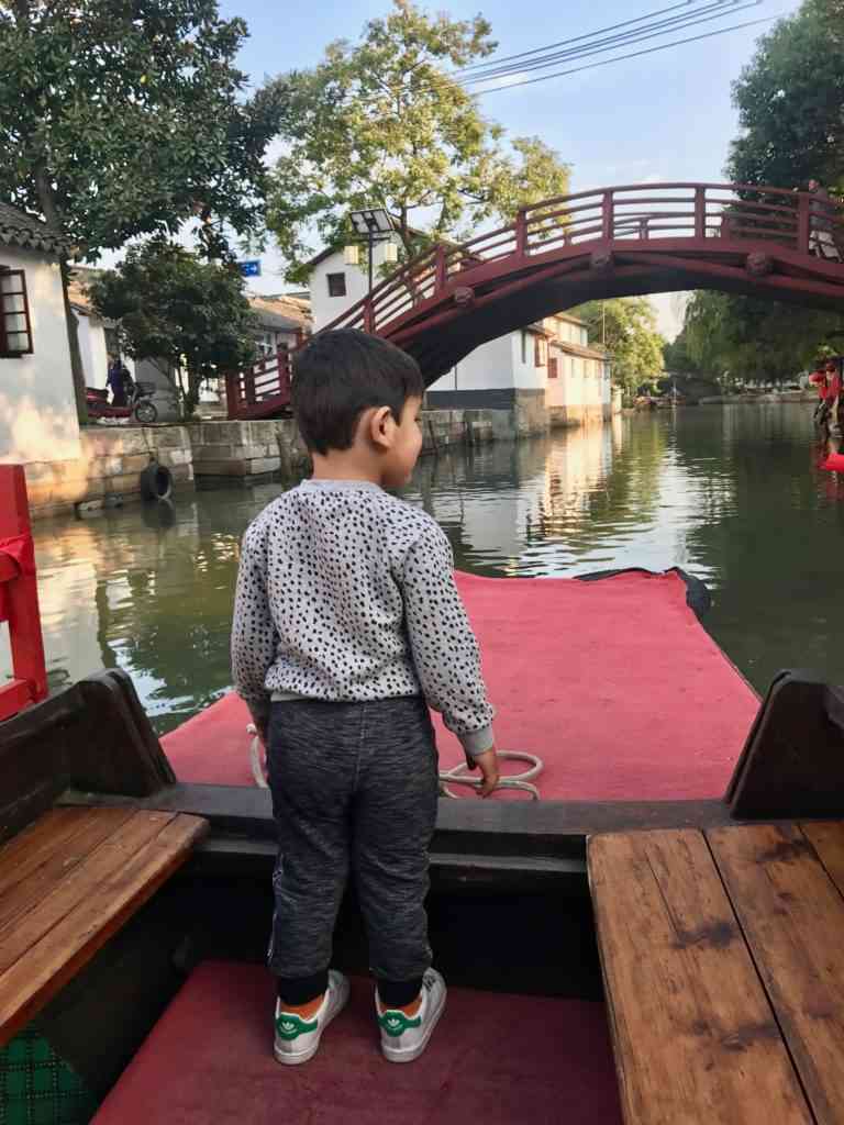 Aarav leading the way on our boat tour in Jinze Ancient Water Town