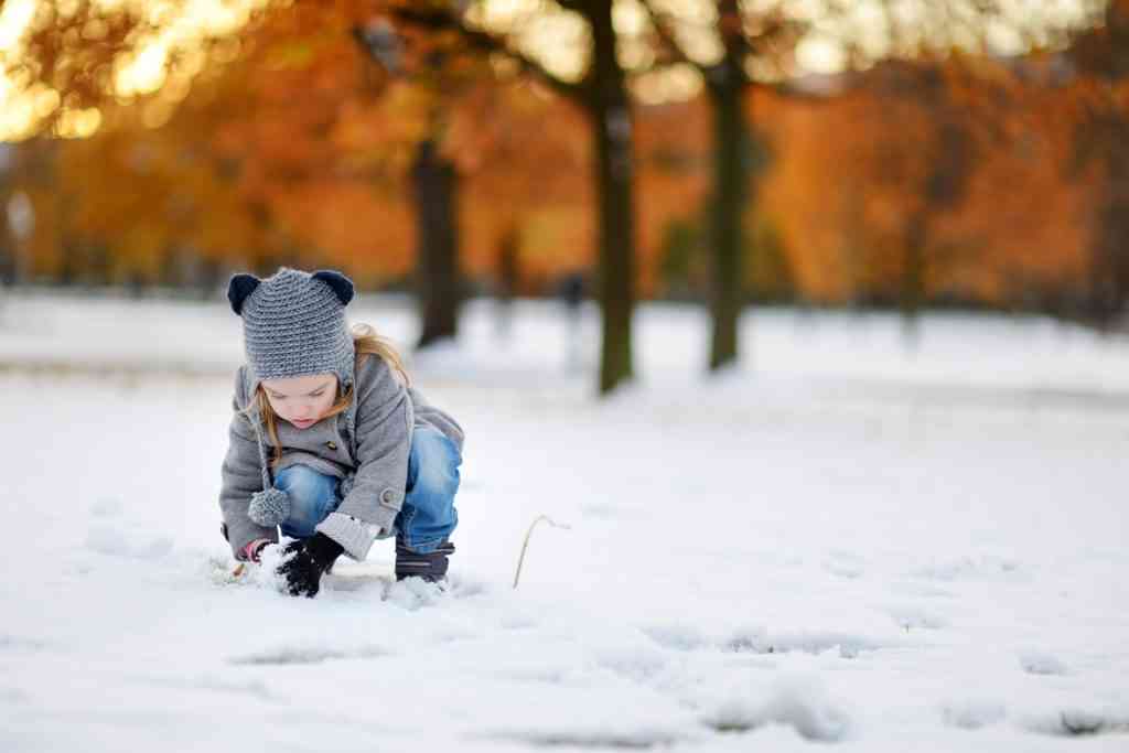 young girl playing in the snow