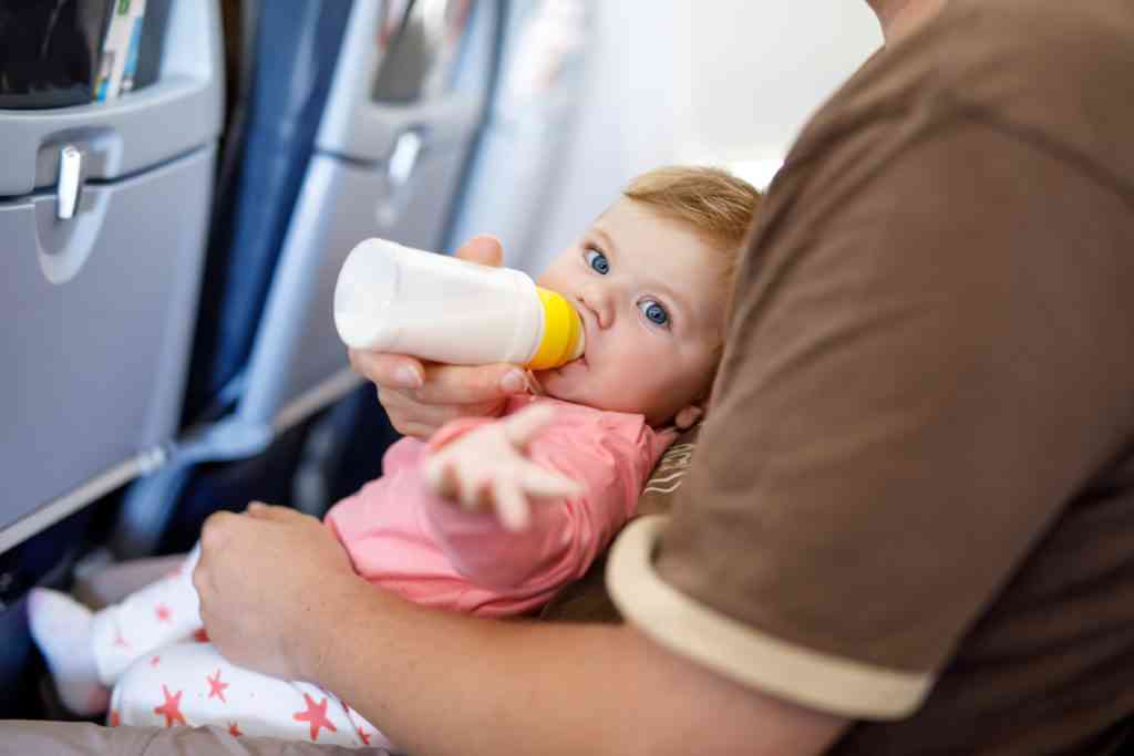 baby drinking bottle on airplane